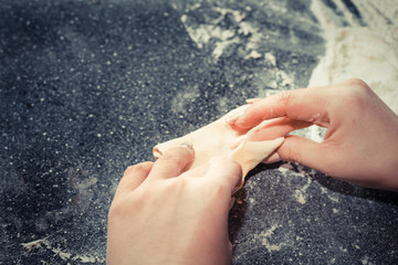 hands of the girl sculpts pies from the dough