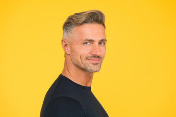 handsome unshaven man. mature macho man yellow background. male hairstyle fashion. skin facial...