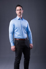 Fototapeta premium young man in a blu shirt and dress pants