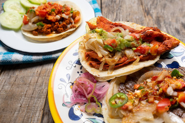 Mexican tacos on wooden background