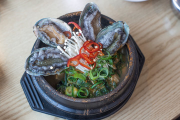 Korean seafood ttukbaeg. Abalone earthen pot stew.