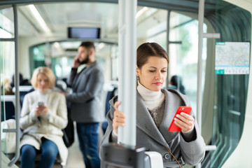 Young woman with phone in public transport