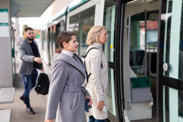 People in hurry to get on tram - obrazy, fototapety, plakaty