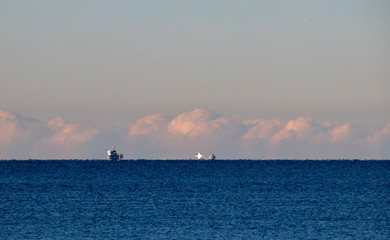 Multiple blurred ships in the distance, dissapearing in the horizon from earth curvature