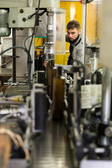 Man controlling olive oil bottling