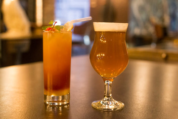 Cocktail and beer glass on wooden table