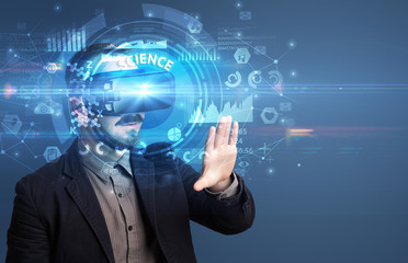 Businessman looking through Virtual Reality glasses with SCIENCE inscription, innovative technology concept