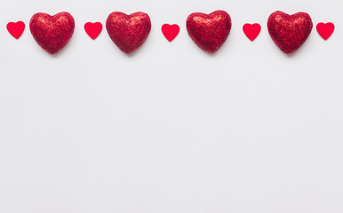 Stock photo of red hearts on a white background with a space for text