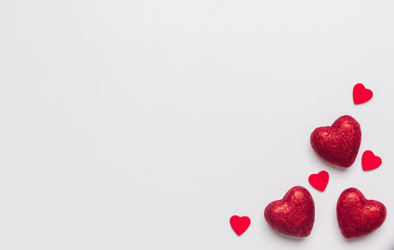 Stock photo of red hearts on a white background with a space for text
