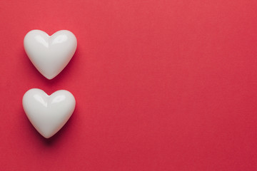 Stock photo of white hearts on a red background with space for text