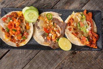 Mexican tacos on wooden background