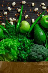 Top view paper bag of different fresh health food on white wooden background. Top view. Flat lay