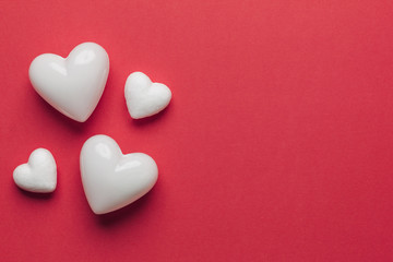 Stock photo of white hearts on a red background with space for text