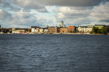 View of the waterfront of Helsinki, Finland, seen from the Baltic Sea with a dramatic cloudy sky