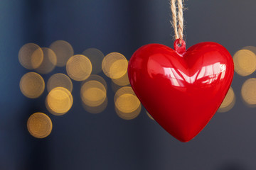 Stock photo of red plastic hearts hanging with an unfocused background