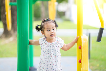 Cute little girl playing at the playground.