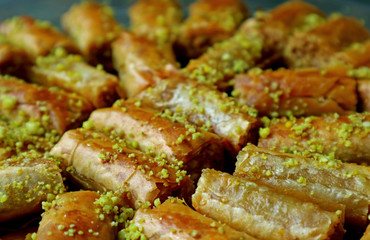 Closeup Heap of Baklava Pastries Topped with Chopped Pistachio Nuts