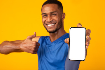 Black millennial guy showing blank phone screen
