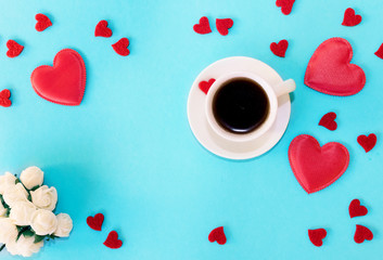 Valentines day background. Red hearts coffee and flower on blue background.