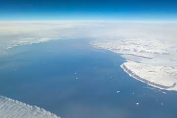 Fototapeta premium An aerial view of a frozen Greenland landscape, taken from an airplane