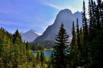Beautiful sunny day in Mount Assiniboine Provincial Park. Mount Assiniboine covered with glacier, blue lake, lush forrest, high mountains. 