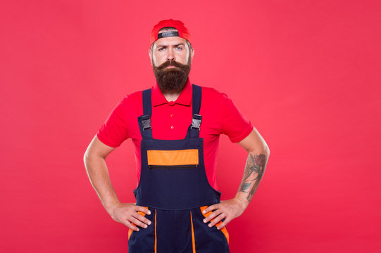 bearded worker. Hard worker red background. Construction worker or miner ready to work. brutal hipster search craftsman career. doing his job professional. First repairer job. serious builder man