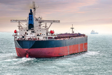 big cargo boat sailing at sunset