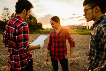 agriculture, gardener, farm, harvest, field, technology concept. A team of farmers conducting...