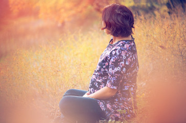 portrait of beautiful pregnant woman in nature