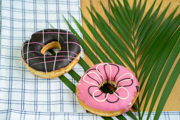 Multicolor donuts on textured wooden butcher
