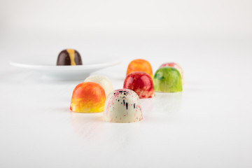 Chocolate art, colorful Chocolate pralines isolated on white, copy space