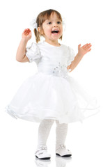 Happy little girl posing in white dress