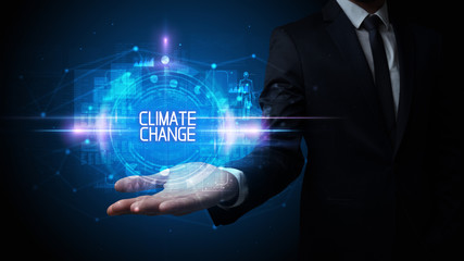 Man hand holding CLIMATE CHANGE inscription, technology concept