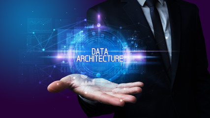 Man hand holding DATA ARCHITECTURE inscription, technology concept