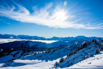 snow covered winter mountain panorama on a sunny day, blue sky