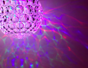 Disco ball with color feflections, lights on the background