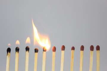 burning match on black background