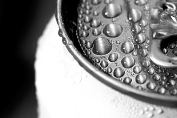 Aluminum can of beverage covered with water drops on background, closeup