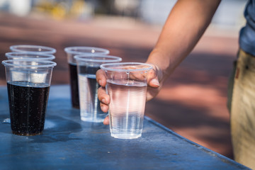 Hand is catching a glass of water.