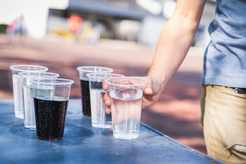 Hand is catching a glass of water.
