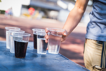 Hand is catching a glass of water.