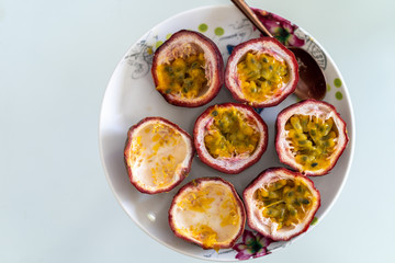 Ripe Passiflora edulis on textured plate.