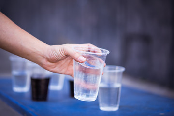 Hand is catching a glass of water.