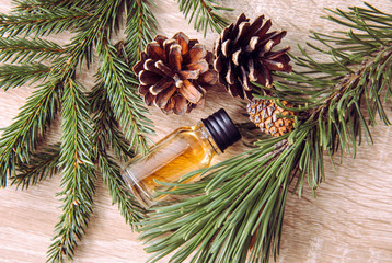 Pine and fir tree aroma oil bottle with pine tree and fir tree branches for decoration on lights...