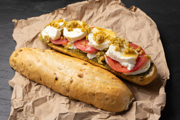 Goat cheese and honey sub sandwich on dark background
