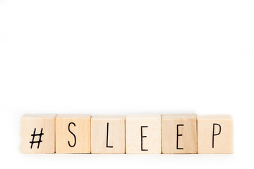 Wooden cubes with a Hashtag and the word Sleep isolated on white background, social media concept...