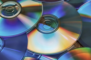 CD copmact discs in a pile making a shiny background