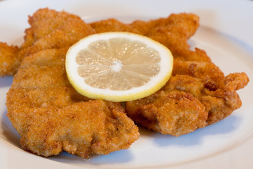 Viennese Schnitzel on a White Plate with Lemon