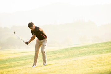 Asian man golfer playing golf at golf course