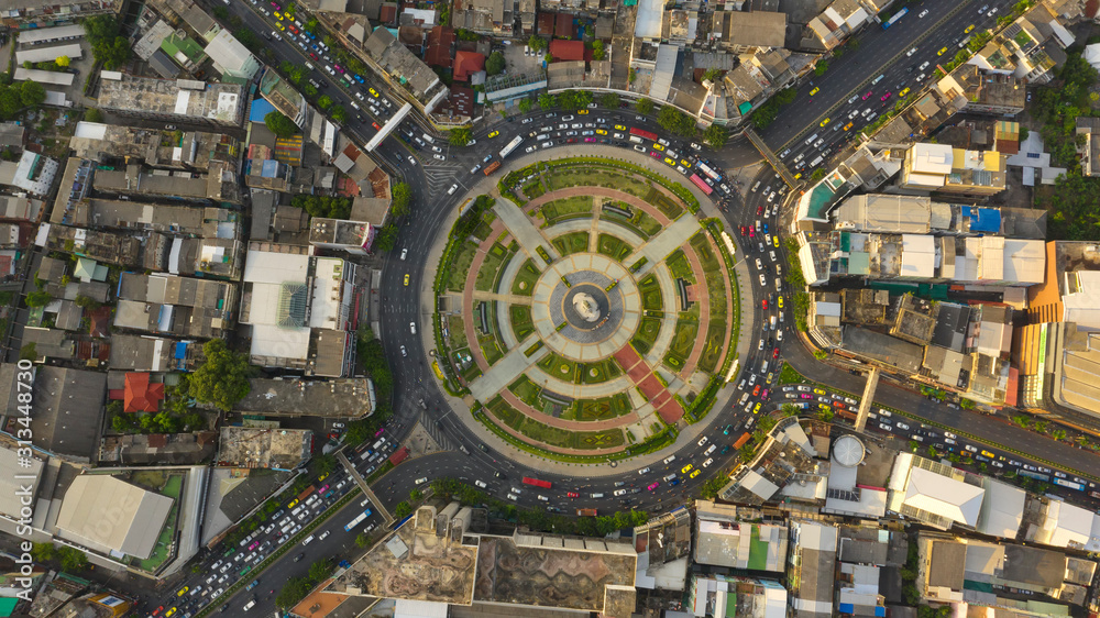 Wall mural Road roundabout with car lots Wongwian Yai in Bangkok,Thailand. street large beautiful downtown at evening light.  Aerial view , Top view ,cityscape ,Rush hour traffic jam. - Wall murals